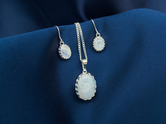 A set of sterling silver necklace and earrings with rainbow moonstone gems