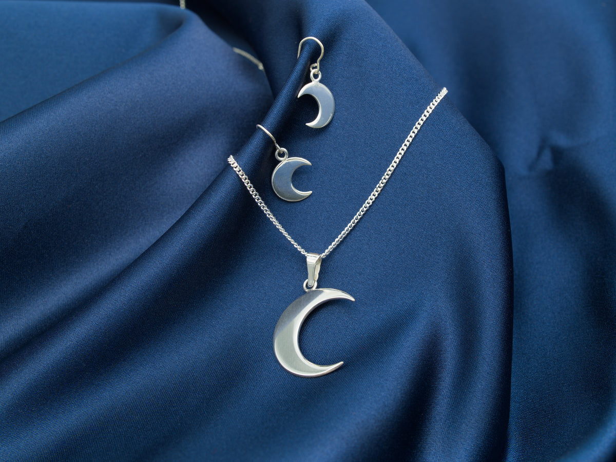 A set consisting of a sterling silver crescent moon necklace and earrings