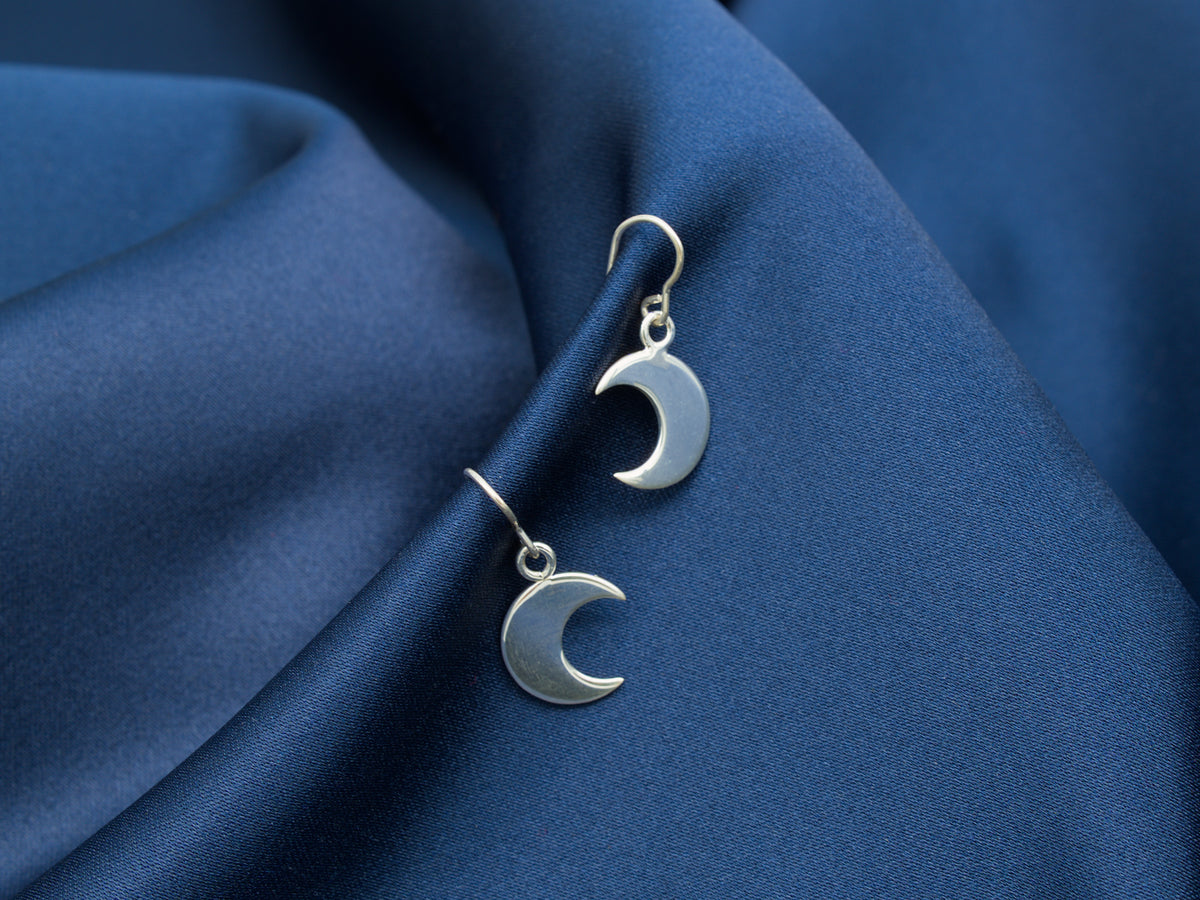 A pair of small sterling silver crescent moon earrings