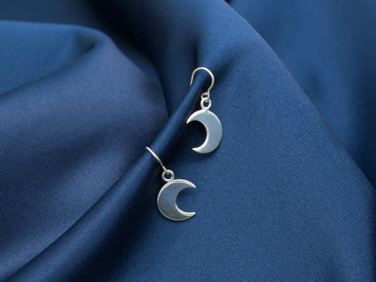 A pair of small sterling silver crescent moon earrings