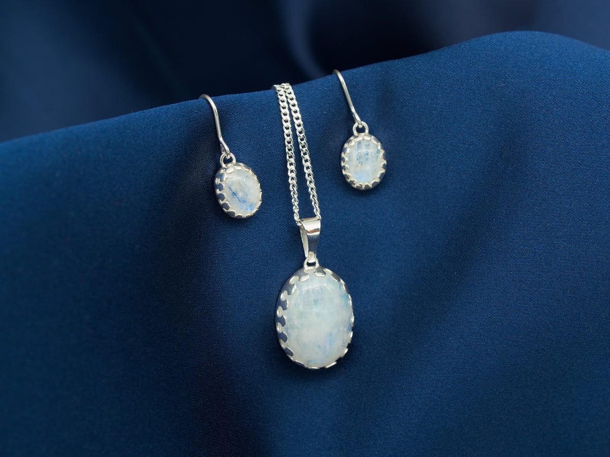 A set of sterling silver necklace and earrings with rainbow moonstone gems