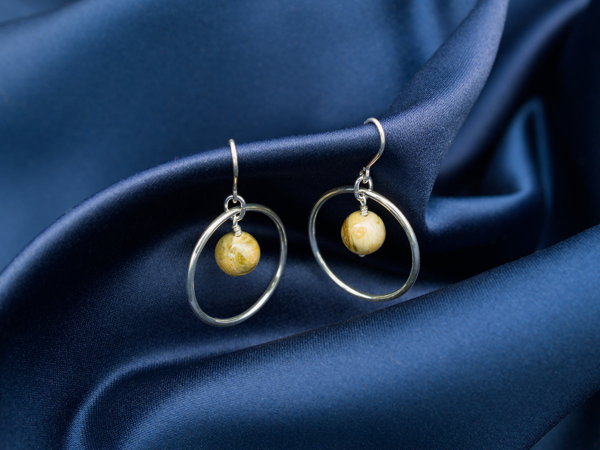 Pair of sterling silver hoop earrings with a light brown jasper stone in the middle
